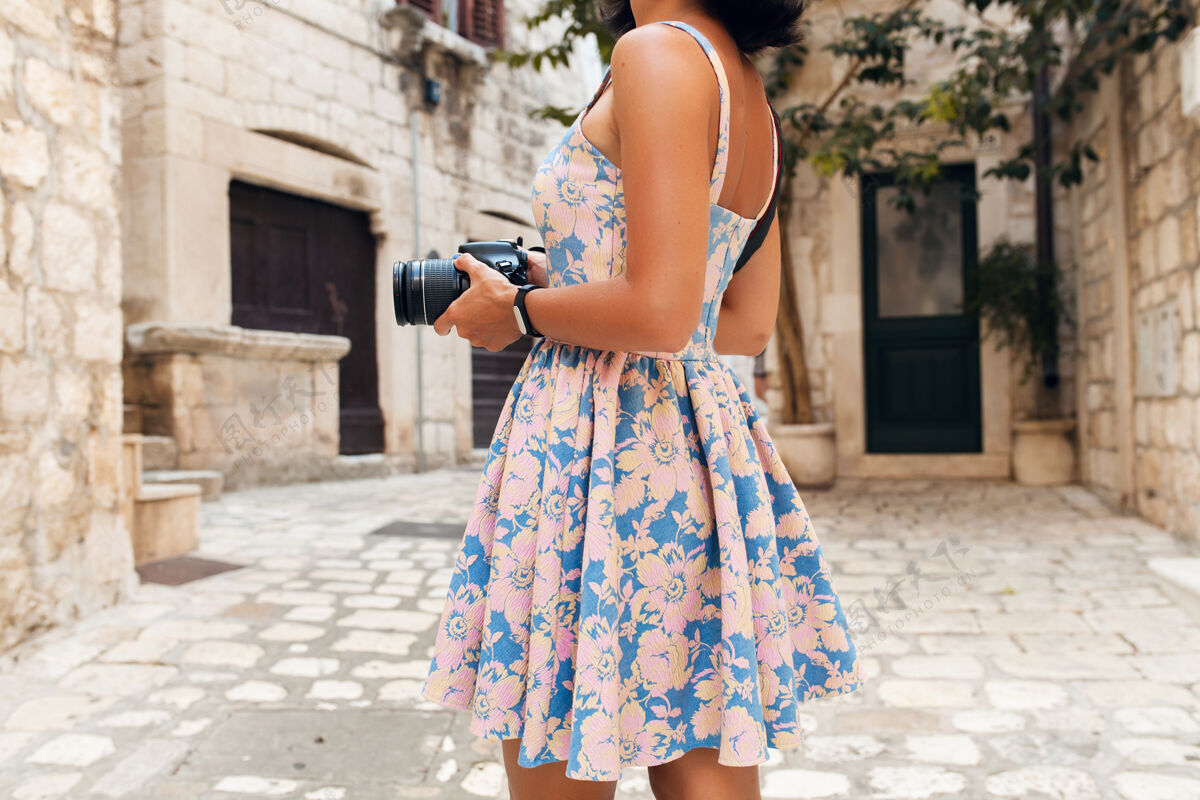 春天在意大利老城区度假时 一个穿着长裙的漂亮女人在用相机拍照装束衣服旅游