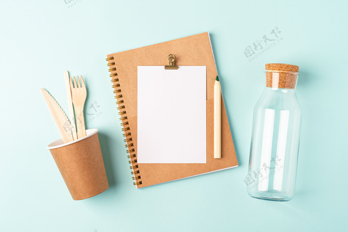 笔记本桌面计划器平铺的蓝薄荷桌顶视图玻璃罐 咖啡杯公寓规划师零
