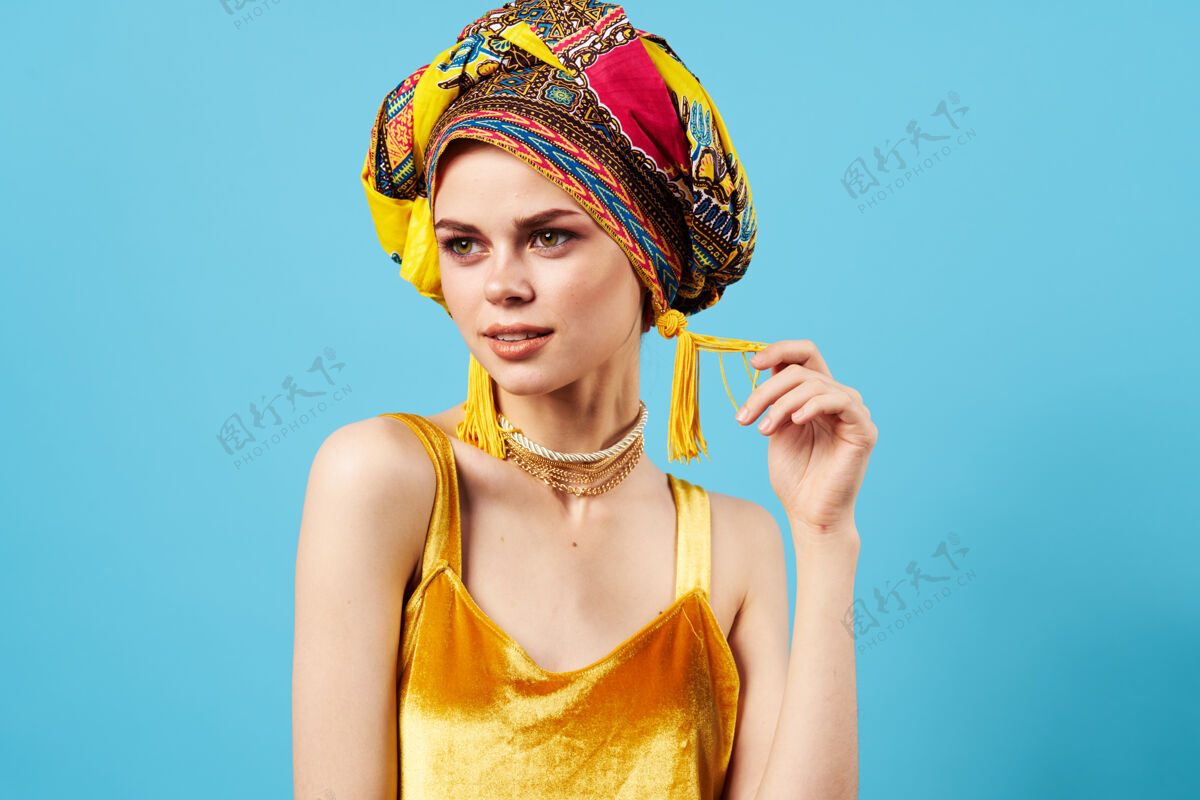 护理美丽的女人民族珠宝头巾黄色礼服摆姿势女性美女珠宝