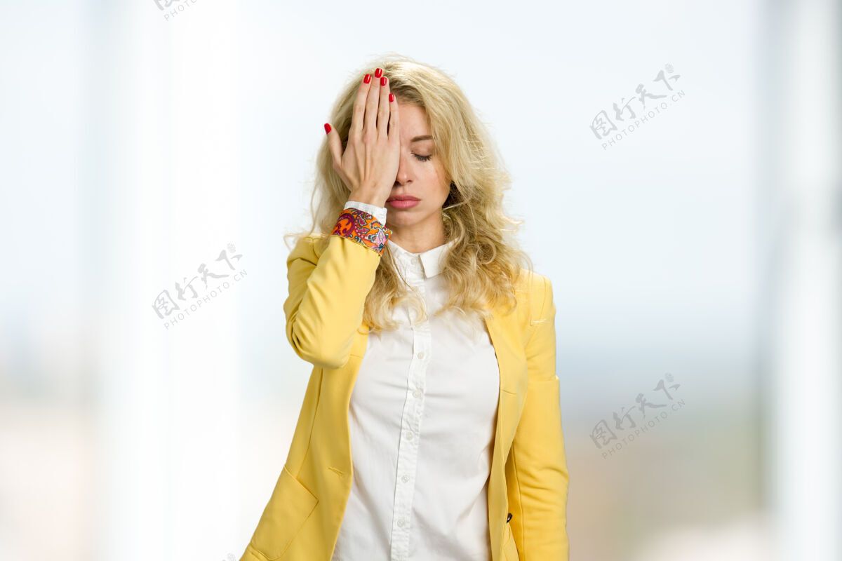 情感年轻女子捂着眼睛穿正装的金发女子用手捂住半张脸欧洲人聪明办公室