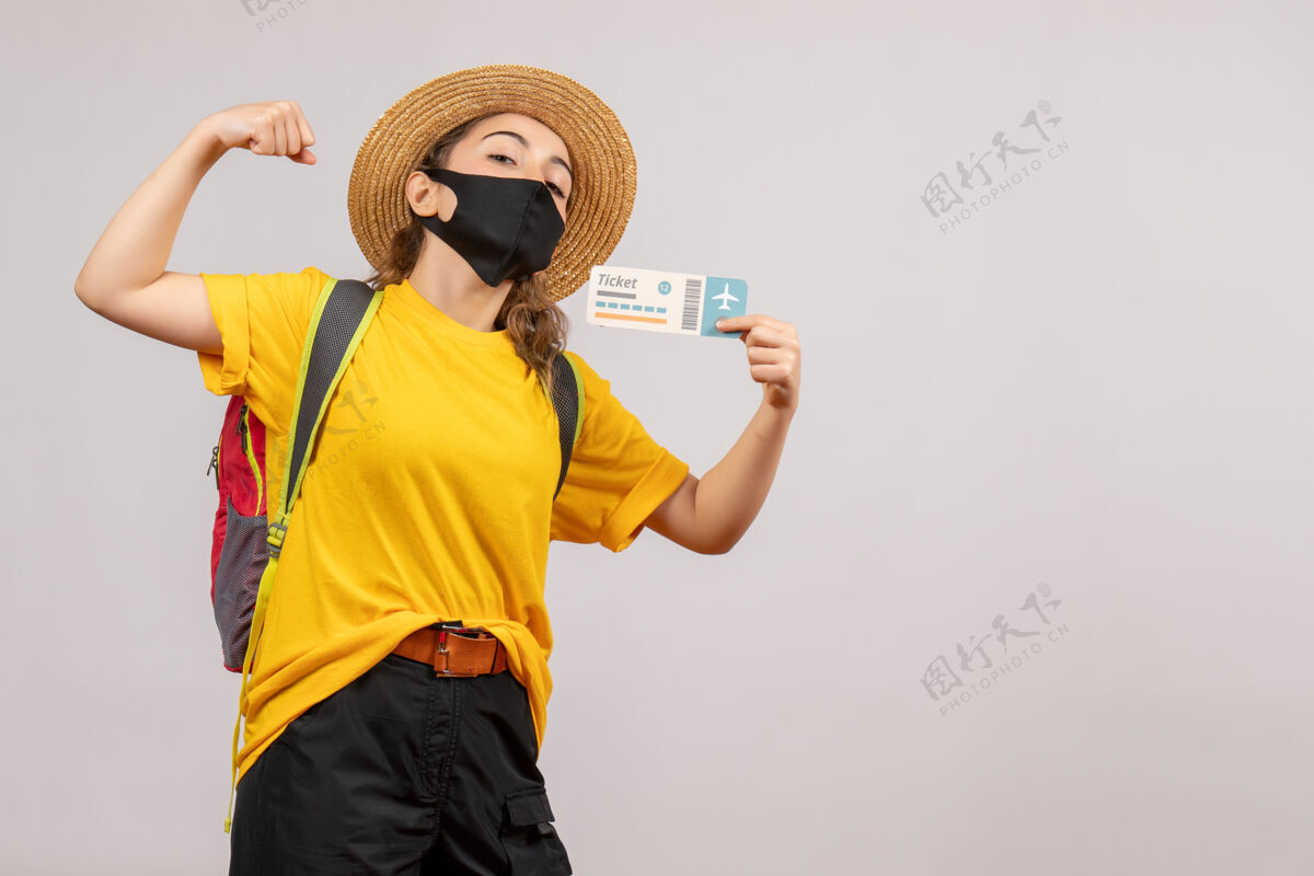 面具正面图年轻旅客背着背包举着车票展示手臂肌肉新常态度假票