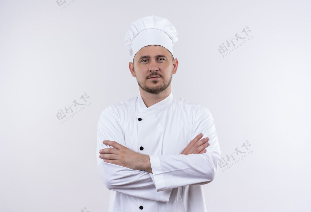 封闭自信的年轻帅哥厨师身着厨师制服 以封闭的姿势站在白色的墙上帅气姿势厨师
