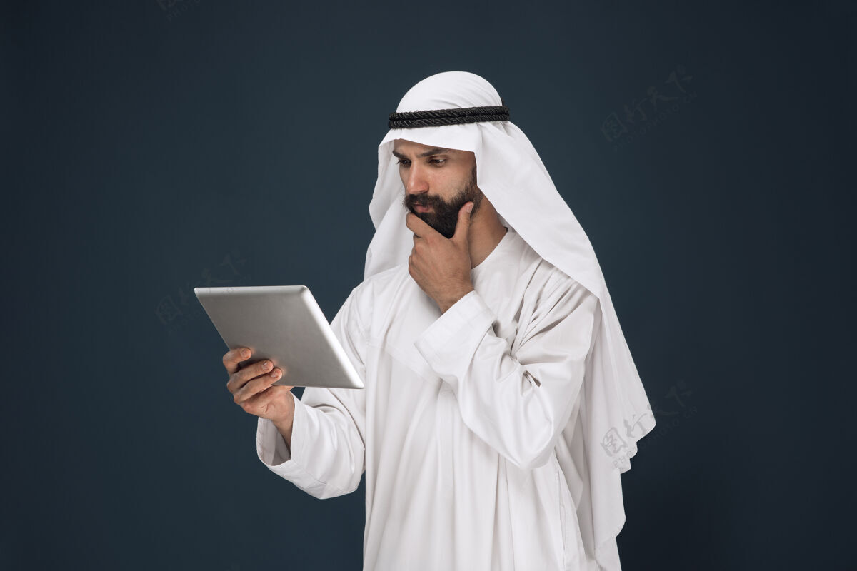 围巾深蓝色墙上的沙特阿拉伯商人文化情绪惊喜