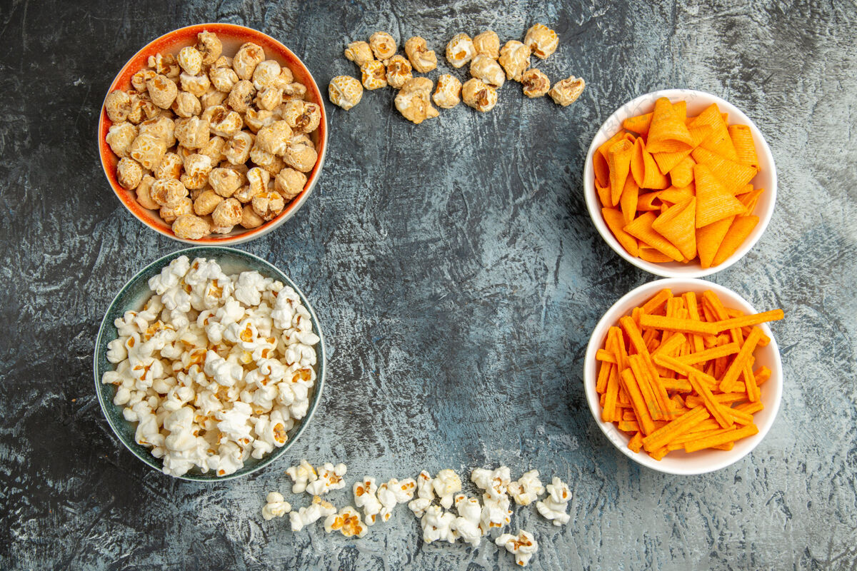 健康顶视图不同的小吃爆米花rusks和cips灯桌上盘子电影小吃