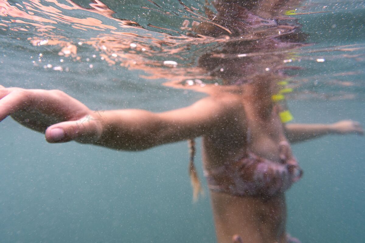 游泳戴着潜水器在海里游泳的女人水上水水肺潜水
