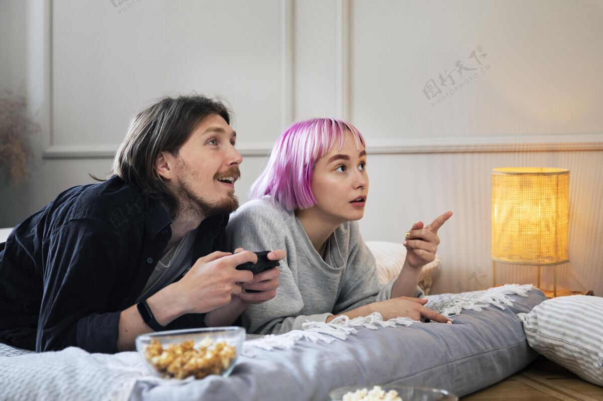 虚拟在室内玩电子游戏的年轻夫妇女人视频游戏科技