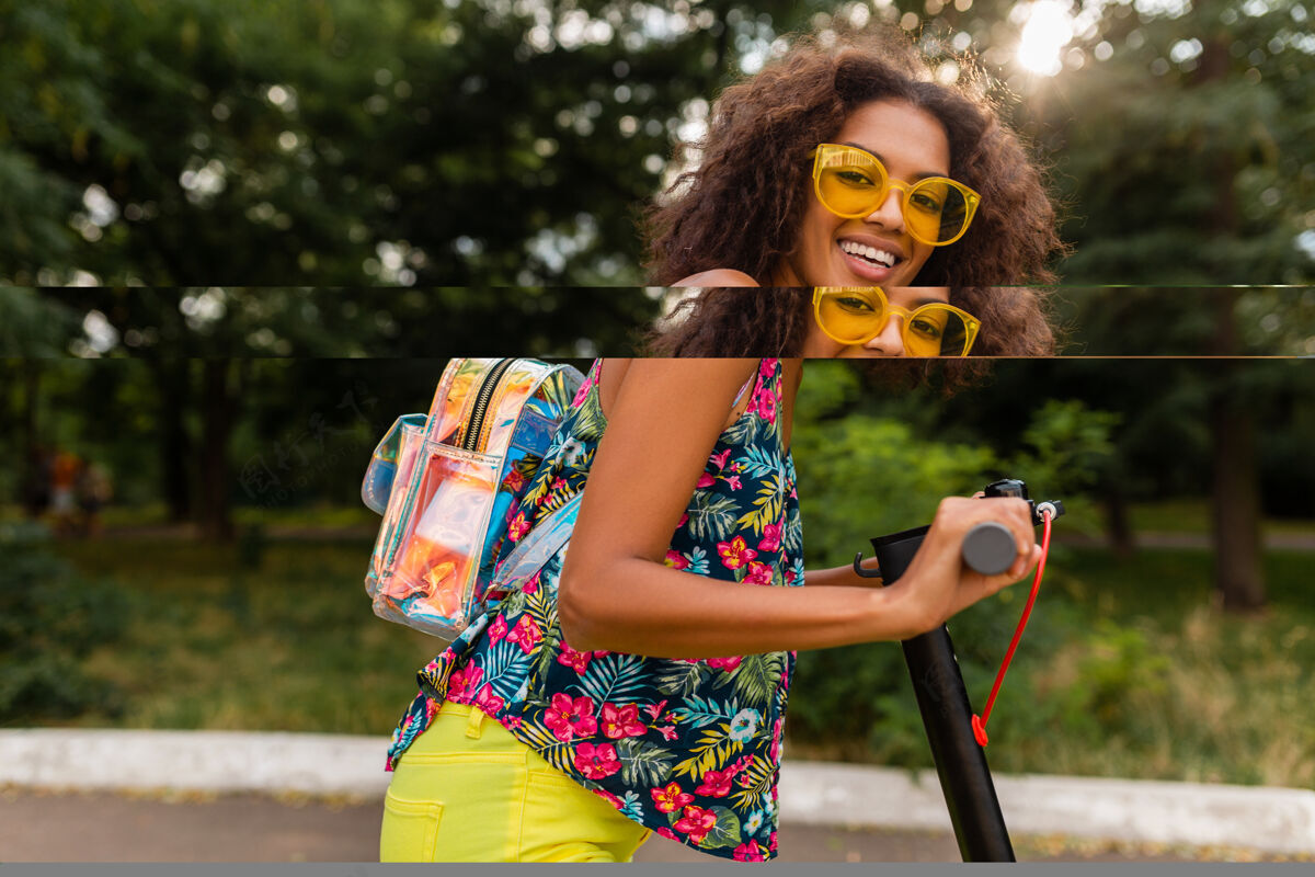 人年轻时尚的黑人女子在公园里玩得很开心骑着电动脚踏车在夏天的时尚风格 五颜六色的时髦服装 穿着背包和黄色太阳镜酷欢呼积极