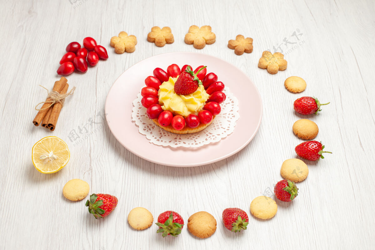 前台前视美味的饼干与水果和蛋糕上的白色办公桌水果茶饼干甜点水果小吃浆果