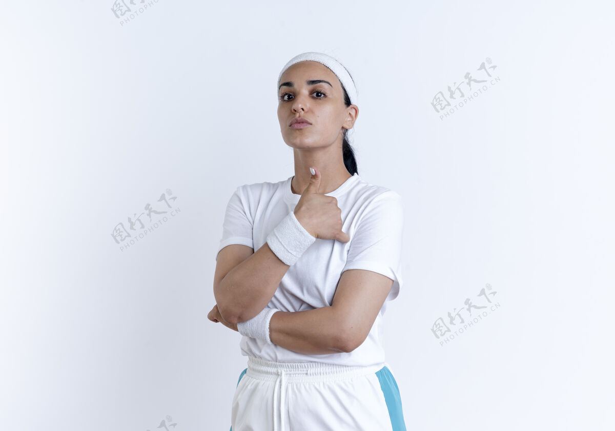 拇指年轻自信的白人运动女性戴着头带和腕带交叉双臂 竖起大拇指 在空白处与复制空间隔离腕带穿女人