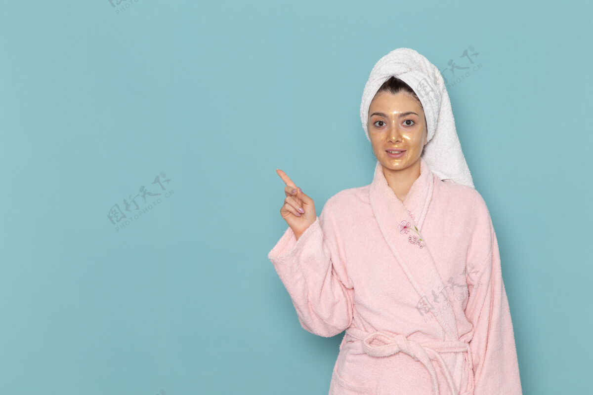 后面正面图身着粉色浴袍的年轻女性淋浴后微笑在蓝色墙壁上美丽的水霜自助淋浴浴室成人前面女性
