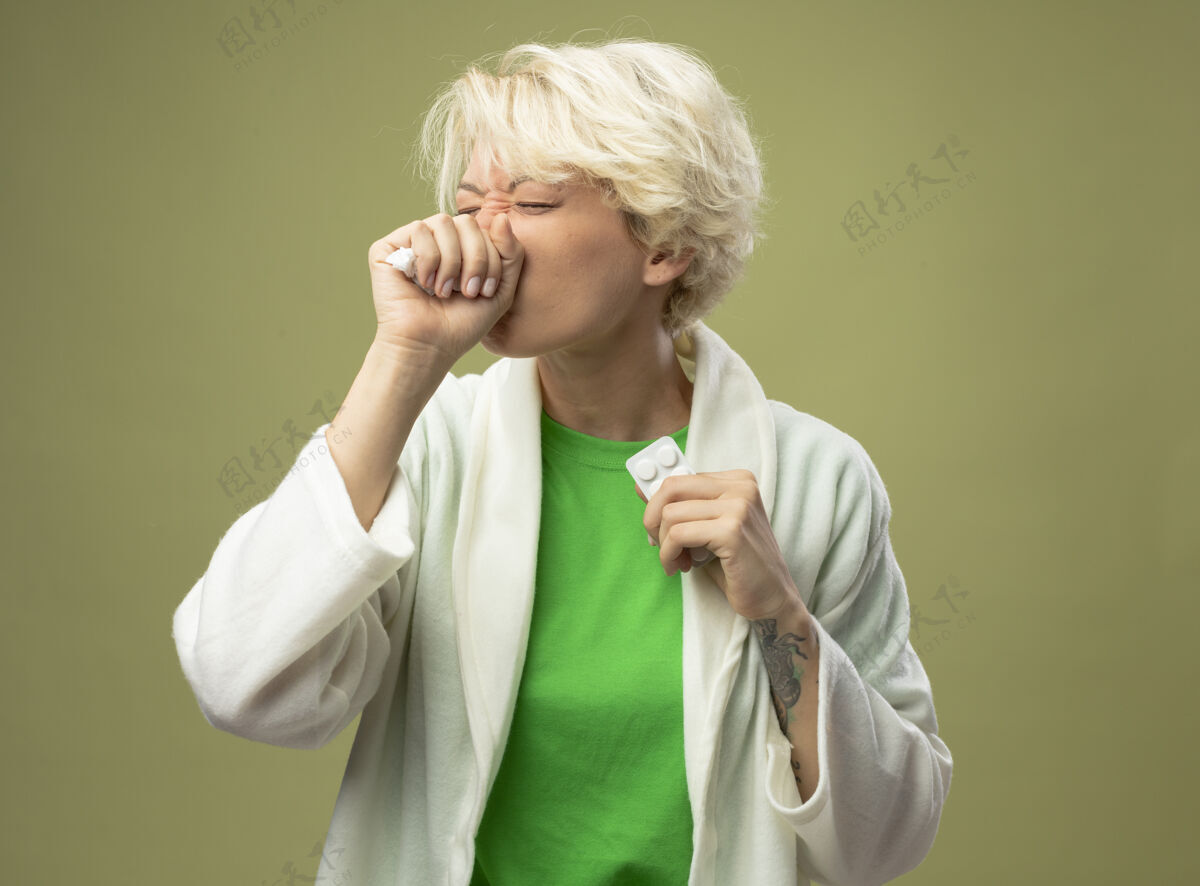 短短发病妇手握药站在浅色背景下咳嗽不适站头发咳嗽