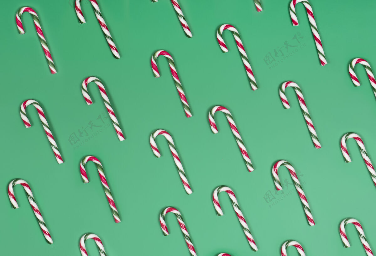 糖果绿色背景上的糖果手杖美味节日庆祝