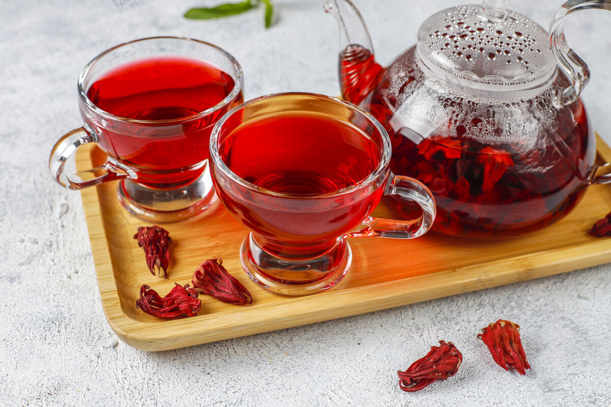 抗氧化剂热木槿茶在一个玻璃杯子和玻璃茶壶茶饮食香料