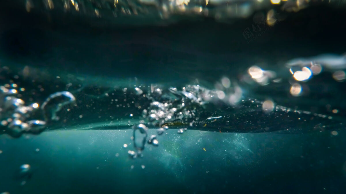 液体海水中漂浮在水面上的气泡的水下视图海水阳光度假