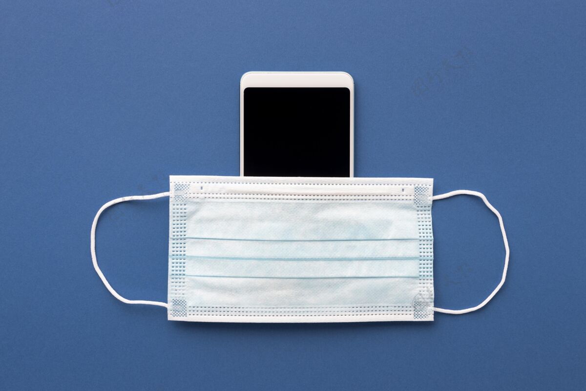 冠状病毒带智能手机的医用口罩平板顶防护